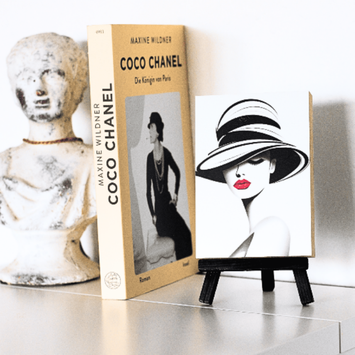 Kleine Staffelei mit Holzbild auf einem Schrank